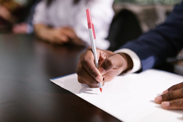 business-person-writing-on-paper business-person-writing-on-paper