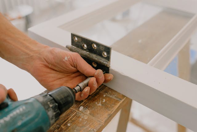 person-fixing-door-hinge