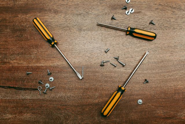 screwdrivers and screws on a wooden table