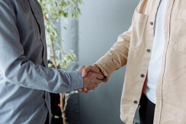 two people shaking hands inside
