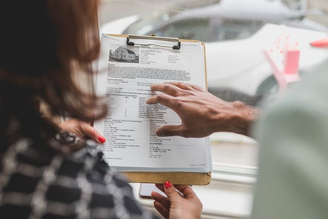 people reading a property feature sheet